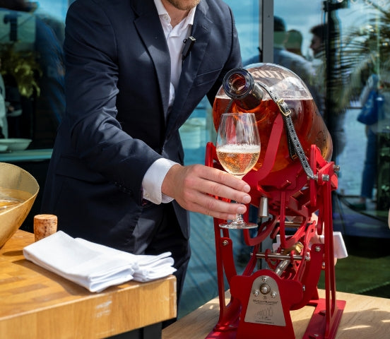 Large-format wine being poured from a MagnuMaster cradle