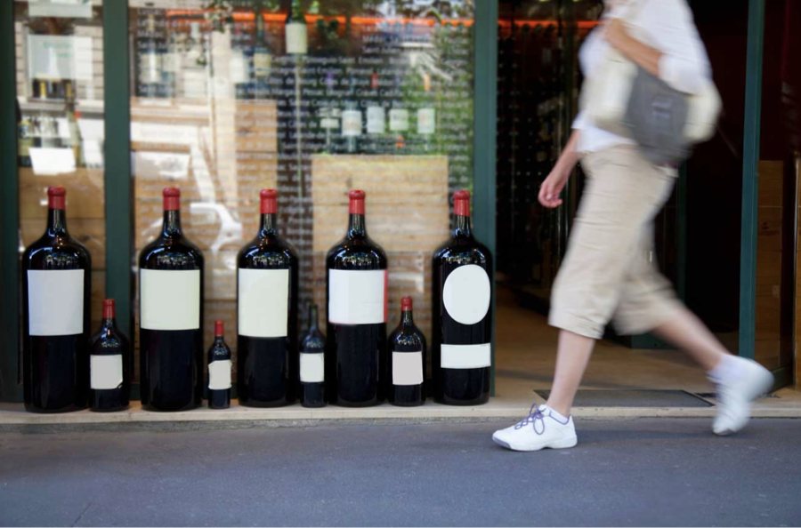 Large-format wine bottles lined up outside a wine merchant