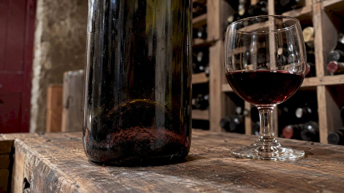 Dark sediment settled in an aged red wine bottle