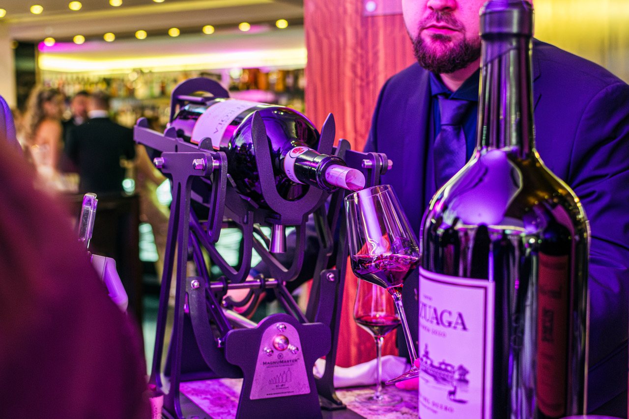 A sommelier pouring a large format tableside with a MagnuMaster